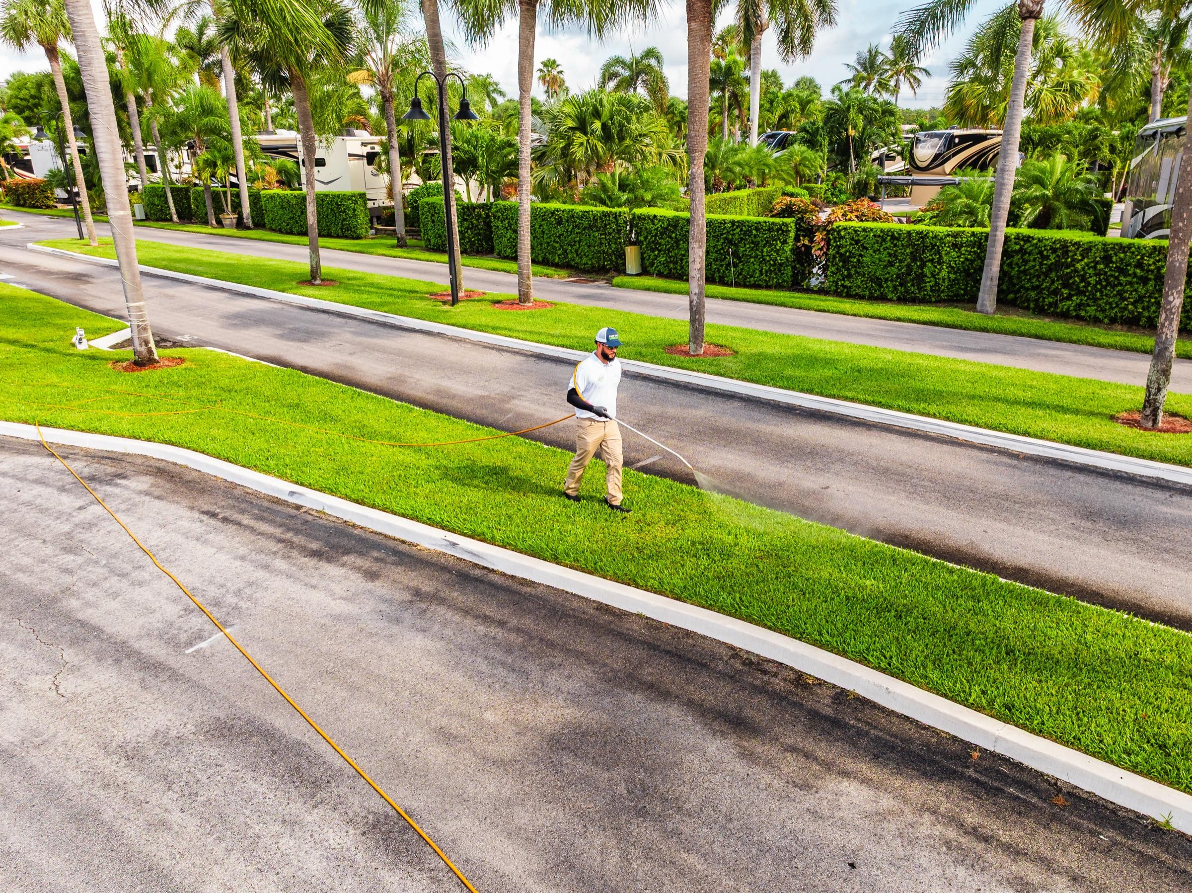 Aerial of a perfectly maintained lawn strip in a South Florida community