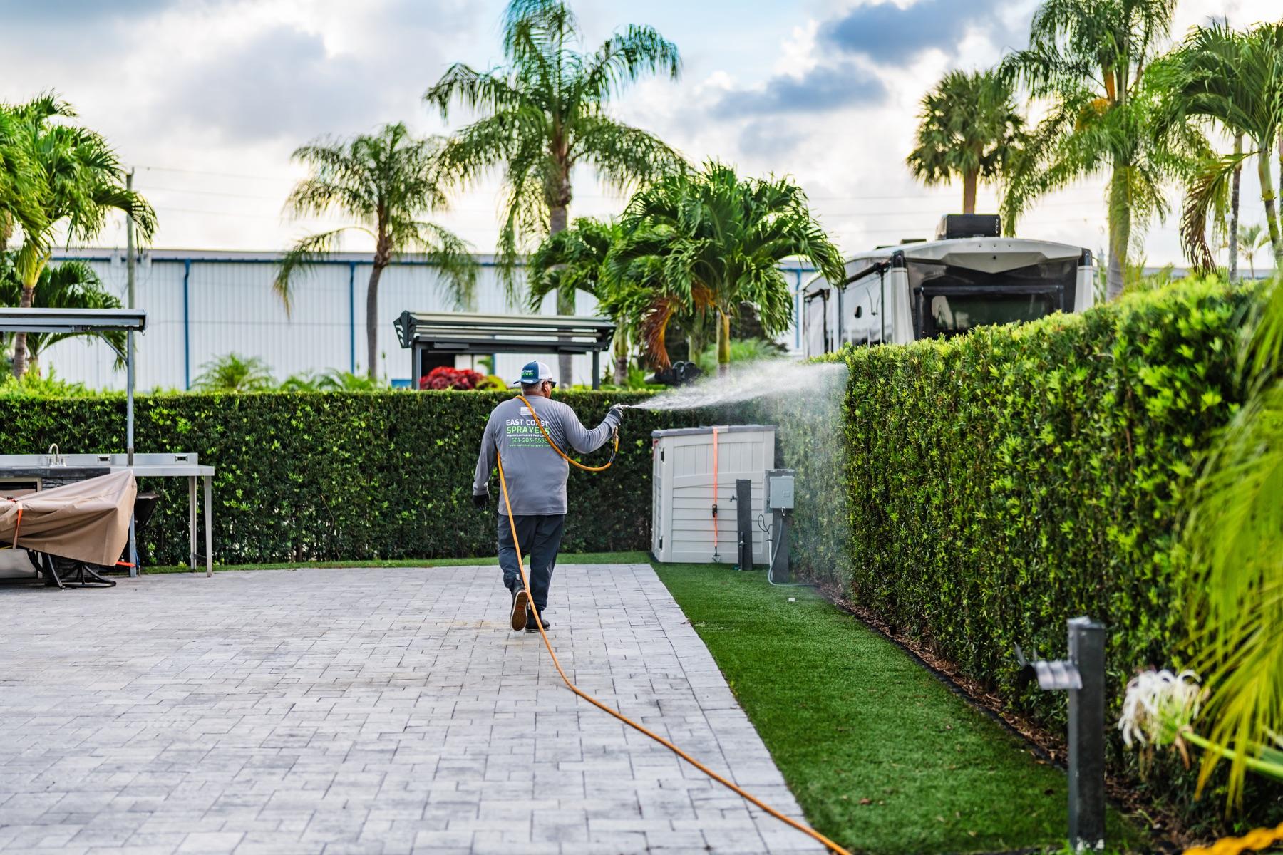 Commercial landscape spray treatment at a property in Palm Beach County
